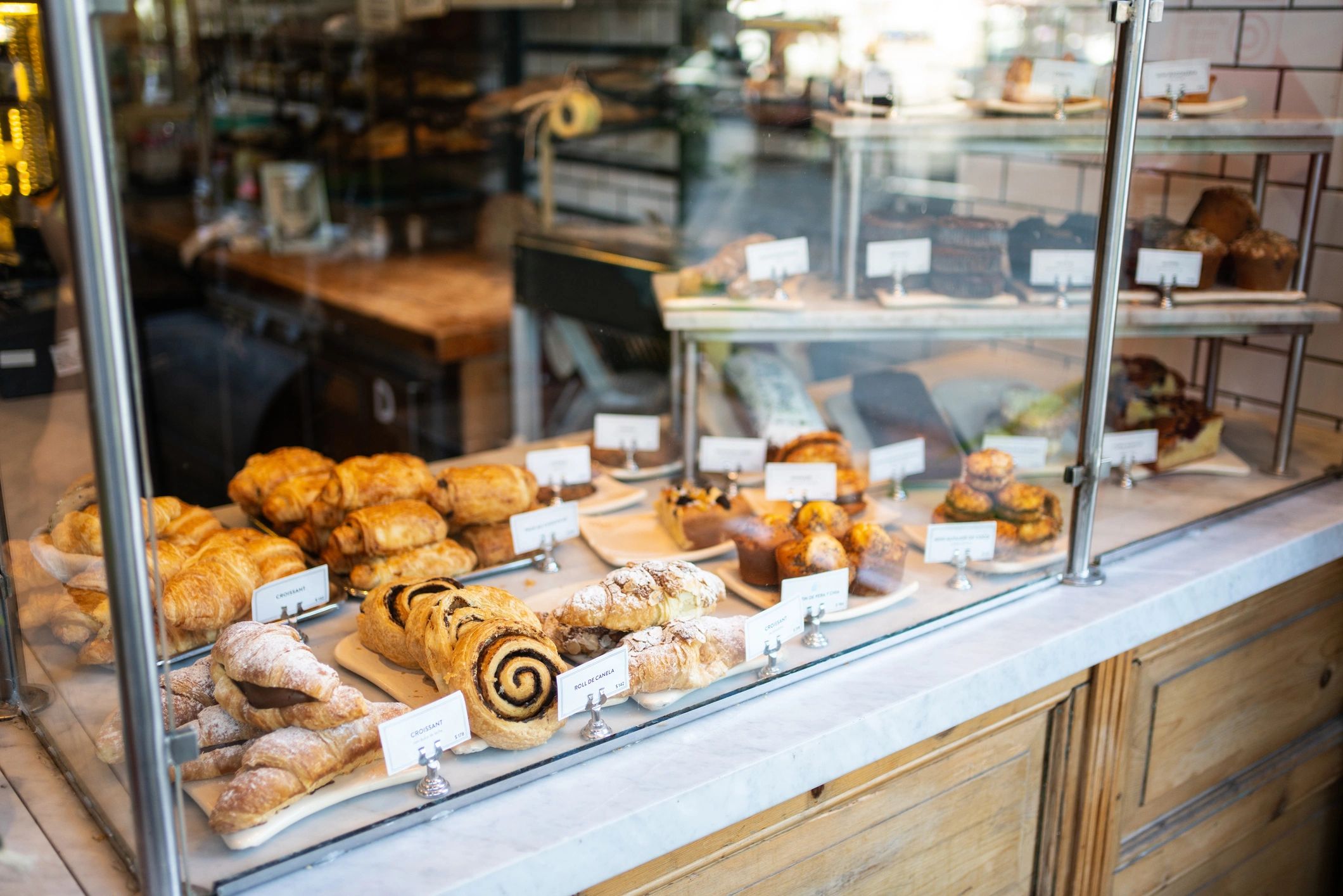 Assorted baked goods displayed in a bakery glass cabinet