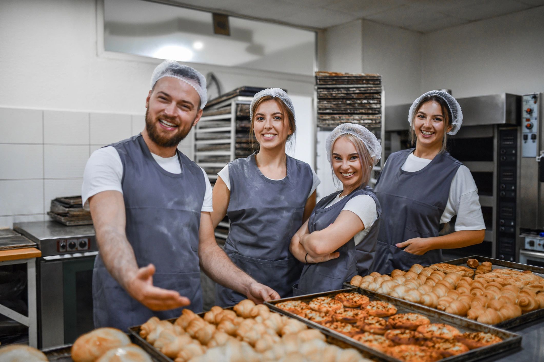 Bakery team presenting freshly baked goods